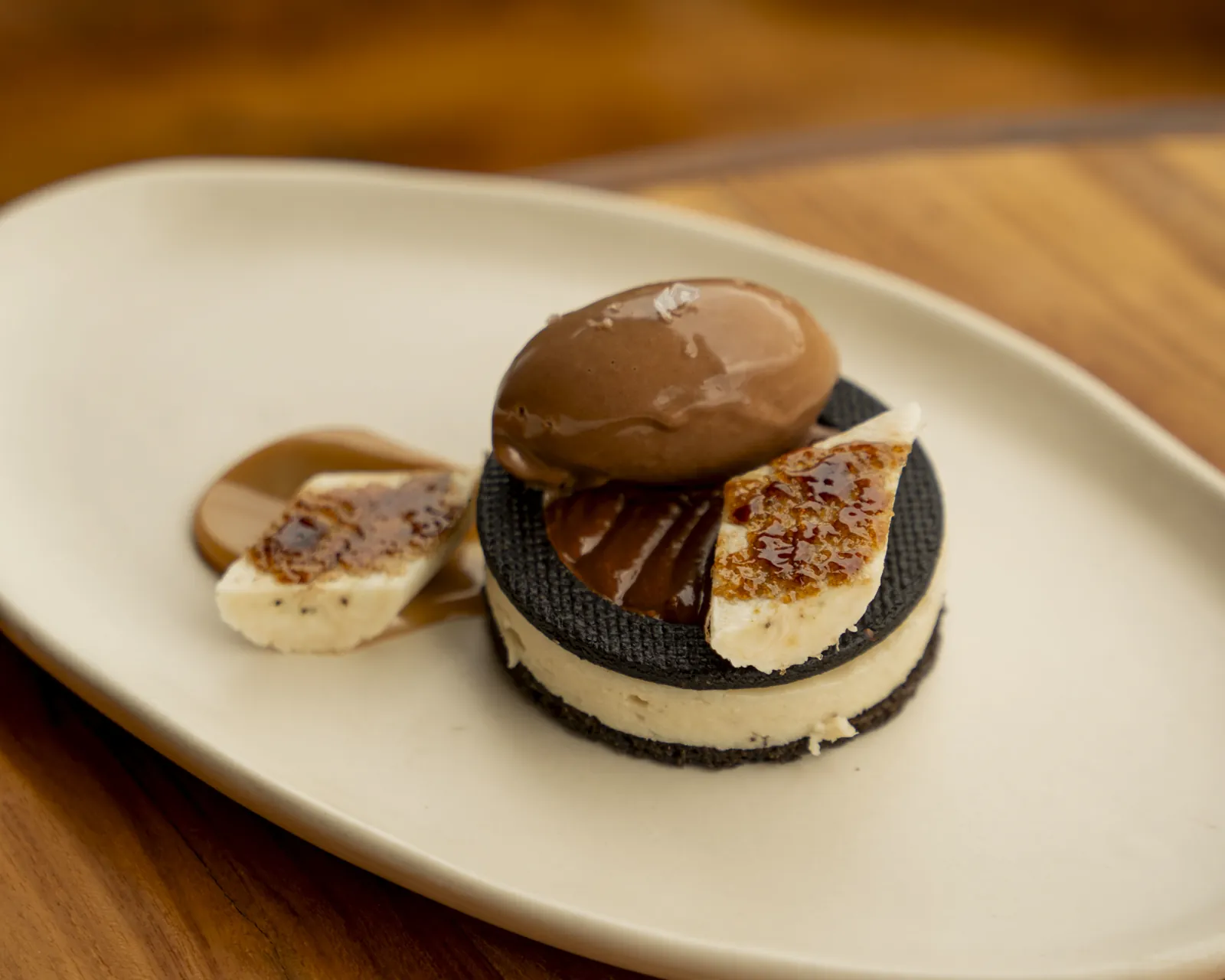 A chocolate and cream dessert on a stoneware plate at Nava