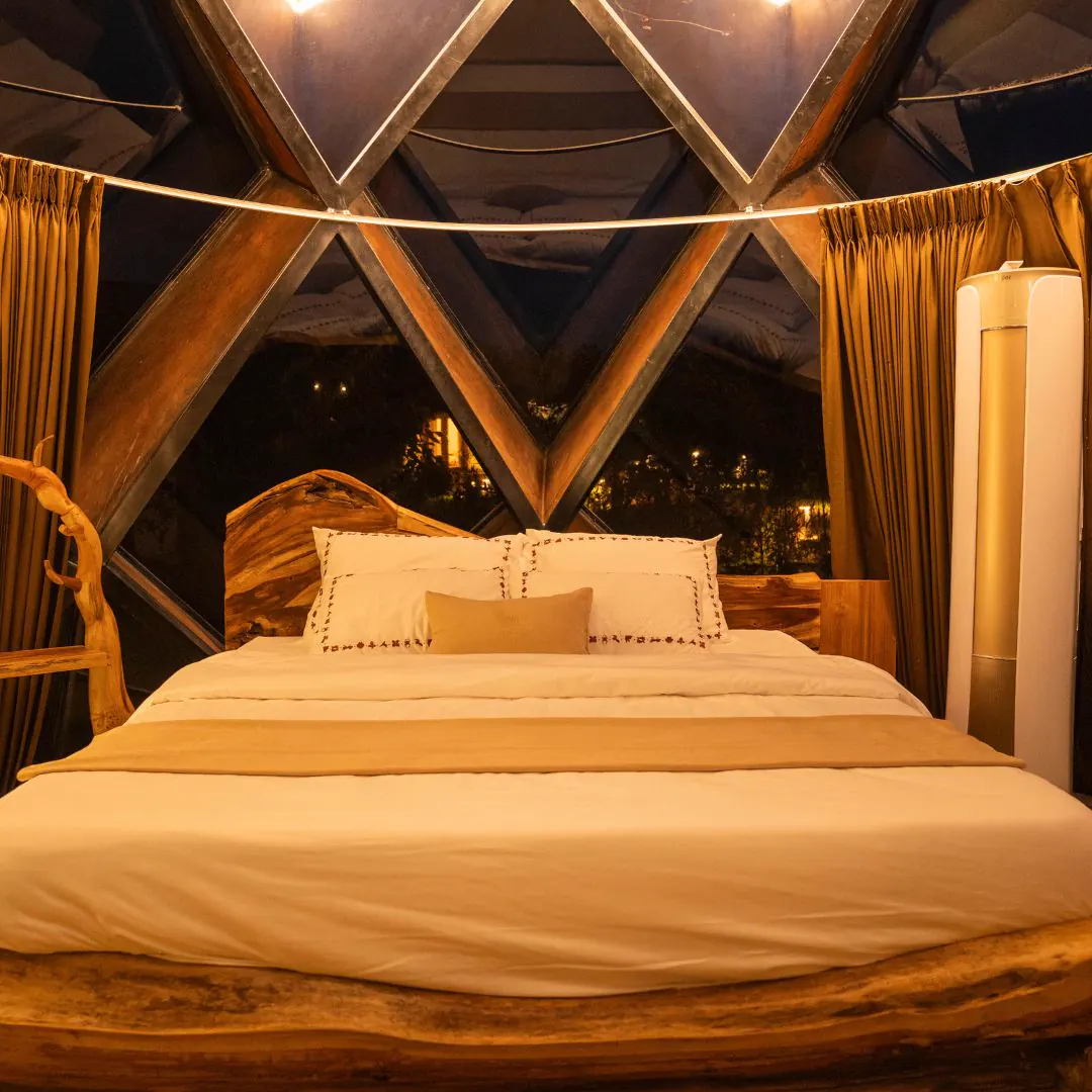 The Amber Chamber — the bed beneath the glass dome