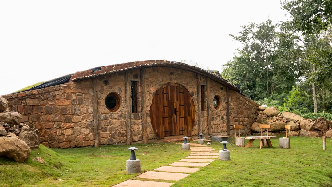 The Burrow — exterior, the stone face and its round door