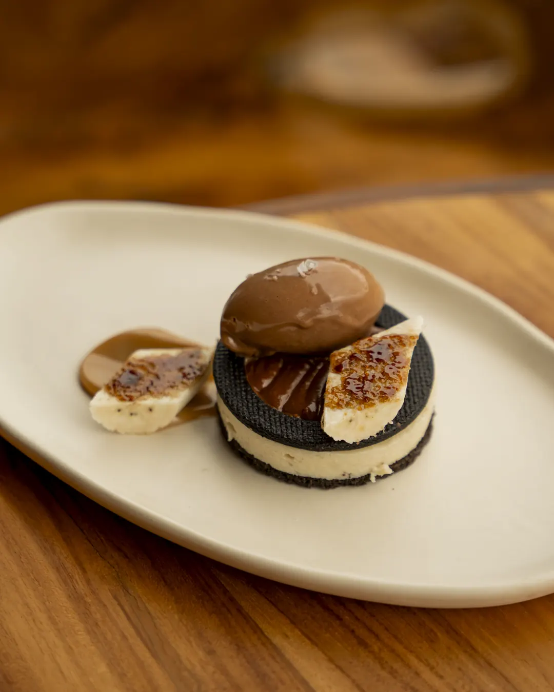 A chocolate and cream dessert on a stoneware plate at Nava